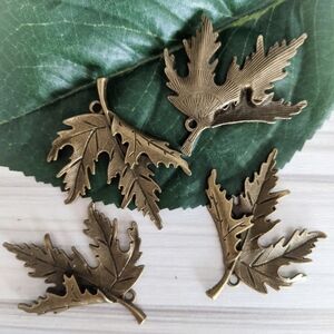 (7/$25) 4 Maple Leaf Pendants - metal embellishments charms
